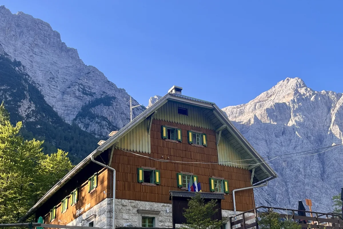 Mountain hut beneath limestone peaks in the Julian Alps, Slovenia